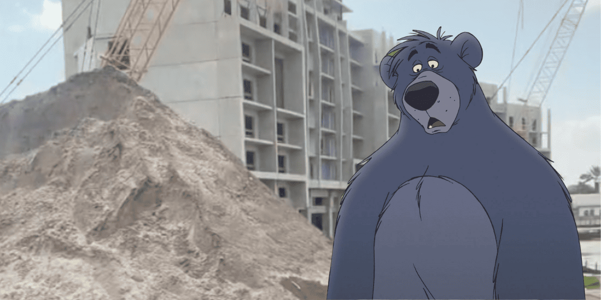 View of an unfinished building, a crane, and a pile of dirt outside a Disney Vacation Club window at Disney's Polynesian Village Resort. Baloo from 'The Jungle Book' is edited in front of the image, looking disappointed.
