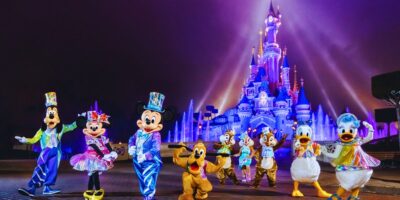 Disneyland Paris with Mickey, Minnie, Donald, Goofy, Daisy, and Chip and Dale in the forefront.