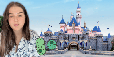 In front of the Disneyland castle, a person with long brown hair is edited next to drawn images of green bacteria.