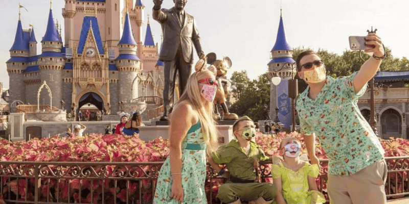 A family in Magic Kingdom wearing masks