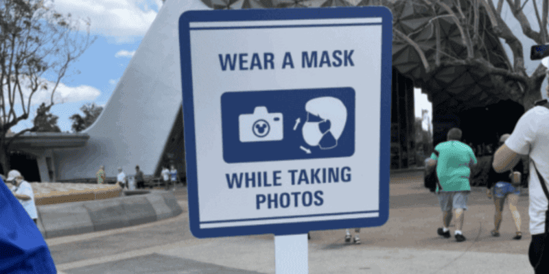 sign during covid asking people to wear a mask while taking photos at EPCOT