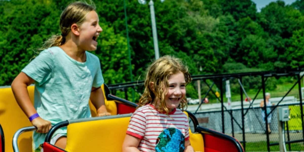 Kids riding the Little Dipper Roller Coaster at Midway State Park