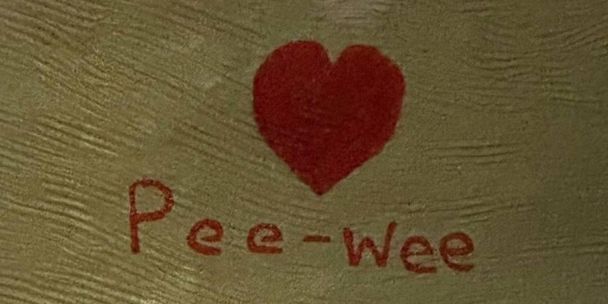Close up of the <3 Pee-Wee tribute on the dinosaur