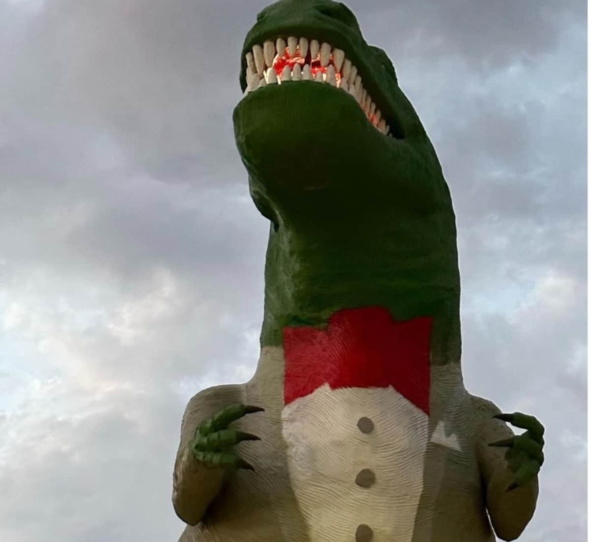 A t-rex dresses as Pee-Wee Herman