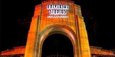 Universal Studios Hollywood entrance at night covered in orange light for Halloween Horror Nights