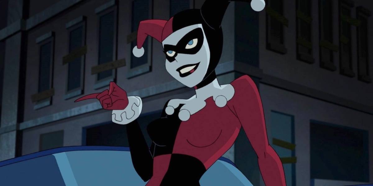 Harley Quinn in her signature jester costume leaning on a car and pointing in Batman the Animated Series