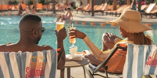 A couple has drinks at the pool of Dockside Inn and Suites