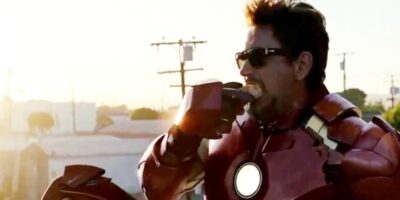 Robert Downey Jr as Iron Man eating a donut