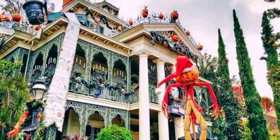 Holiday decorations shown on the outside front portion of the Haunted Mansion at Disneyland Resort in California