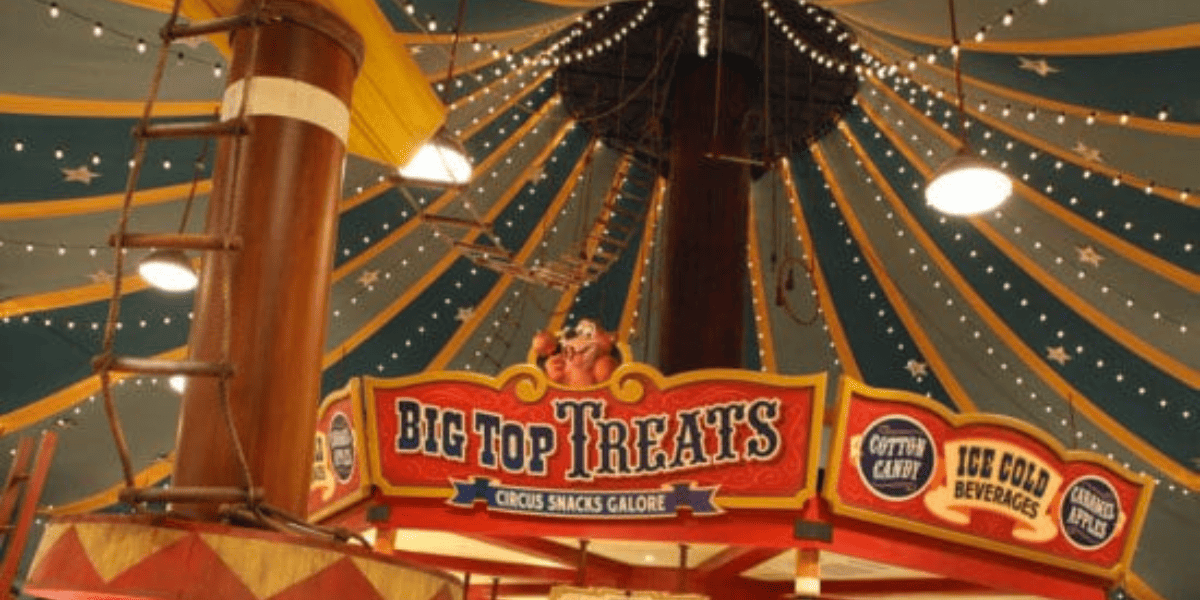 The tent-like ceiling of Big Top souvenirs at Magic Kingdom. A sign reads "Big Top Treats."