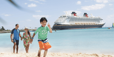 Family running on beach at Castaway Cay