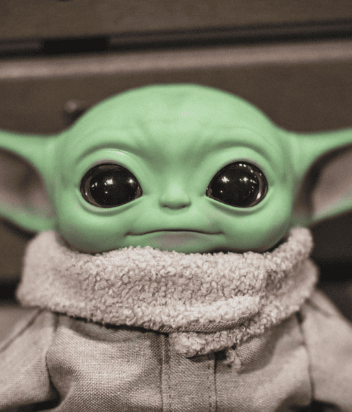 A photograph of an adorable Baby Yoda toy