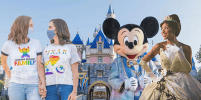 Two women hold hands, Mickey Mouse smiles, Princess Tiana poses - all edited in front of Sleeping Beauty Castle.