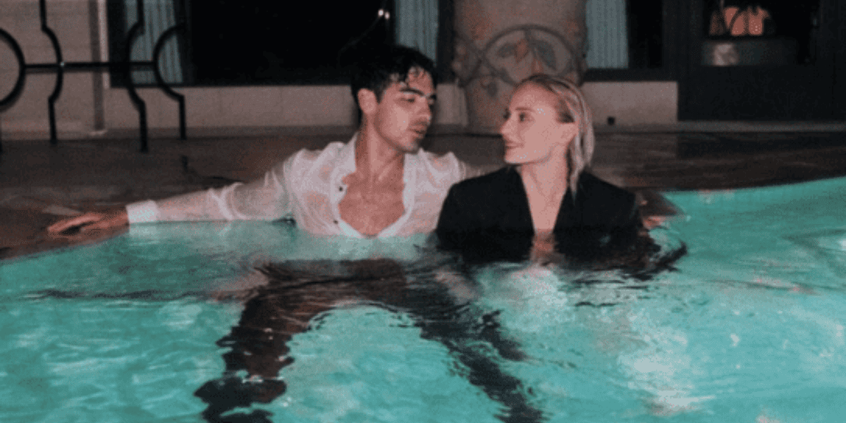Joe Jonas pictured with soon-to-be ex-wife Sophie Turner fully clothed and embracing one another in a swimming pool