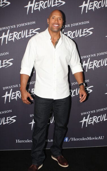 Dwayne Johnson photographed while wearing a white collared and black jeans at the Hercules movie premiere. 