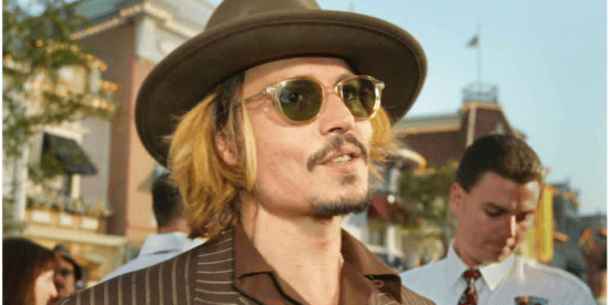 Johnny Depp pictures with a brown shirt, brown hat, and blonde colors hair