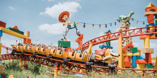 Large Toy Story characters on display as decor for a Toy Story-themed rollercoaster ride
