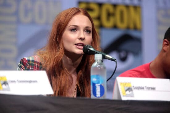 Sophie Turner pictured speaking into a microphone while wearing a plaid shirt at the 2017 San Diego Comic Con International, for "Game of Thrones", at the San Diego Convention Center in San Diego, California.