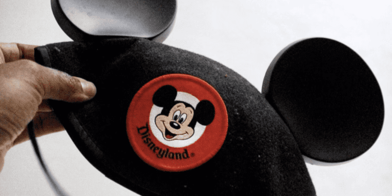 Classic Disneyland Mickey ears being held by a man