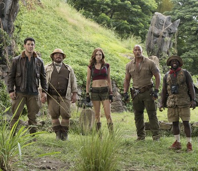 Dwayne Johnson alongside cast mates Kevin Hart, Nick Jonas and others photographed in a scene of the Jumanji: Welcome to the Jungle movie.