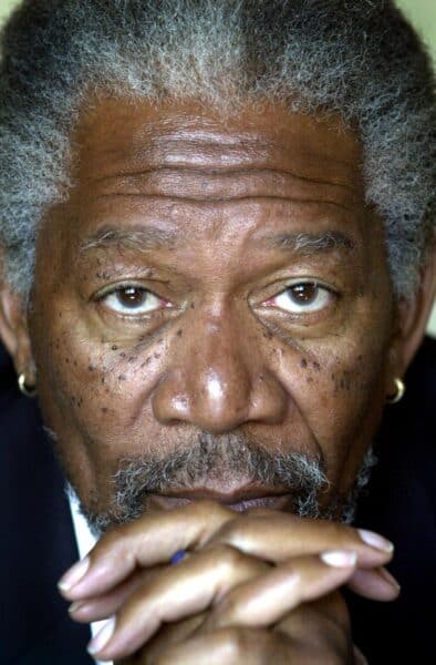 Actor Morgan Freeman posed with both hands clasps together at chin length, while looking directly into the camera