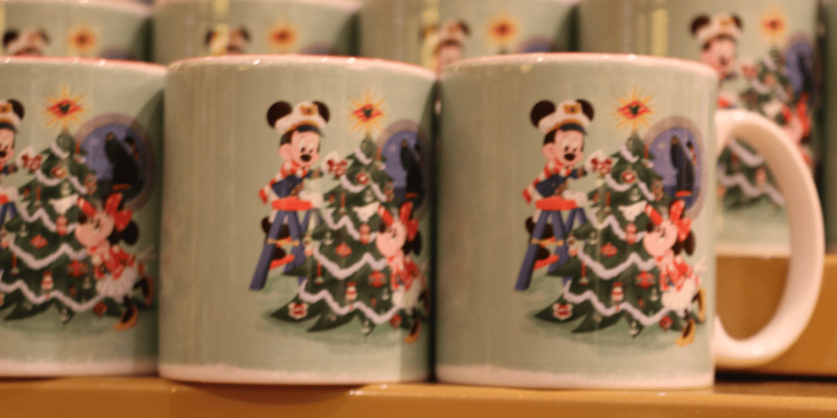 A collection of Disney holiday mugs with a Mickey Mouse and Christmas tree design