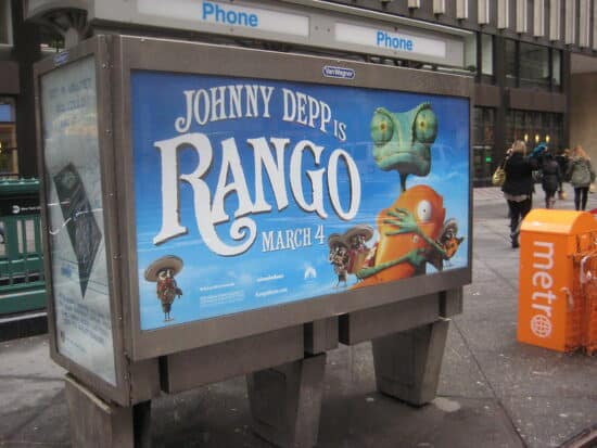 A Rango movie promotion photographed on the backhand side of a public phone station