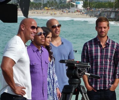 Dwayne Johnson photographed on the beach with Fast Five cast mates Vin Diesel, Paul Walker, and others.