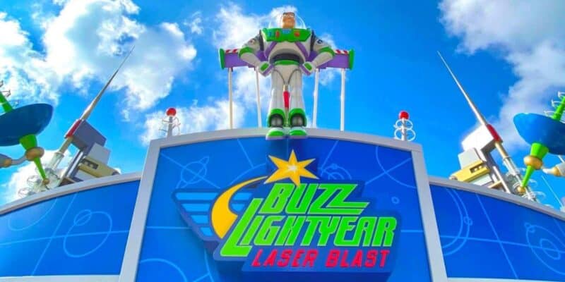 A Buzz Lightyear statue stands on top of the Buzz Lightyear Laser Blast attraction exterior