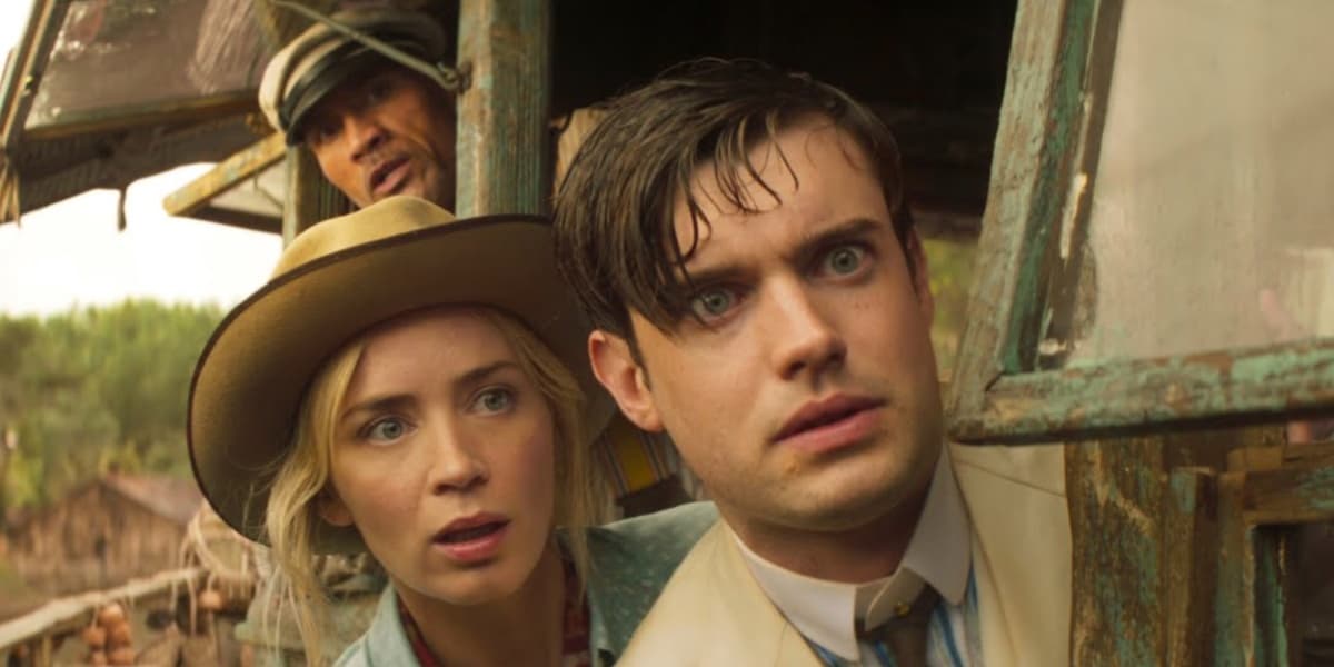 Jack Whitehall, Emily Blunt, and Dwayne Johnson looking terrified on a boat in Jungle Cruise