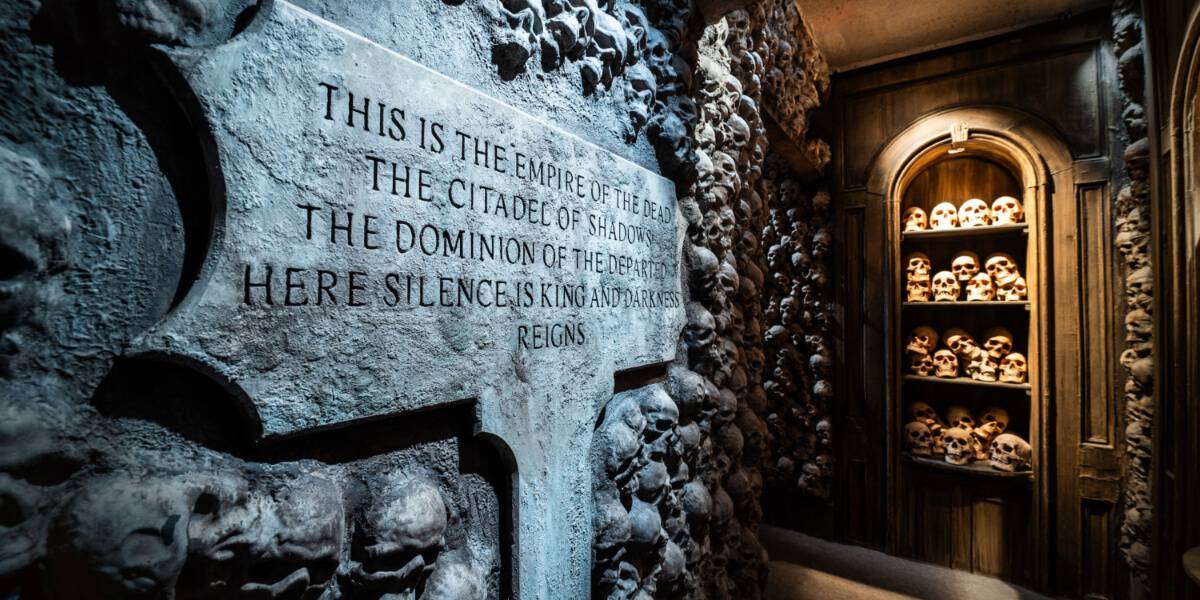 A stone sign introducing you to the Universal Monsters: Unmasked house at Halloween Horror Nights