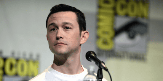 Actor Joseph Gordon-Levitt photographed sitting in front of a microphone while wearing a white t-shirt at Comic Con International