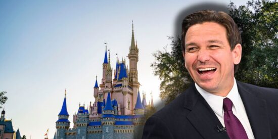 Florida Governor Ron DeSantis smiling while looking at the Cinderella Castle inside the Magic Kingdom at Disney World.