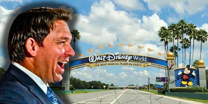 Florida Governor Ron DeSantis laughing in front of the entrance to Walt Disney World Resort