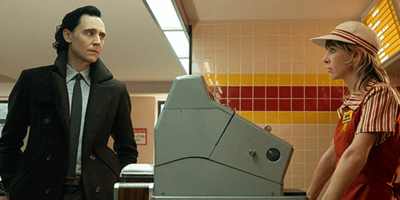 Still from 'Loki' Season two, featuring Loki and Sylvie in a vintage McDonald's looking at each other
