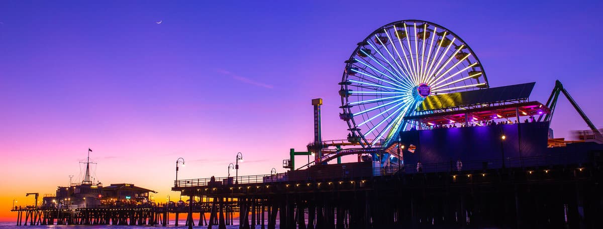 The sun setting on Pacific Park on the Santa Monica Pier in California. 