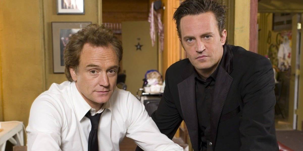 Bradley Witford and Matthew Perry dressed up in an office for a promo photo of Studio 60 on the Sunset Strip