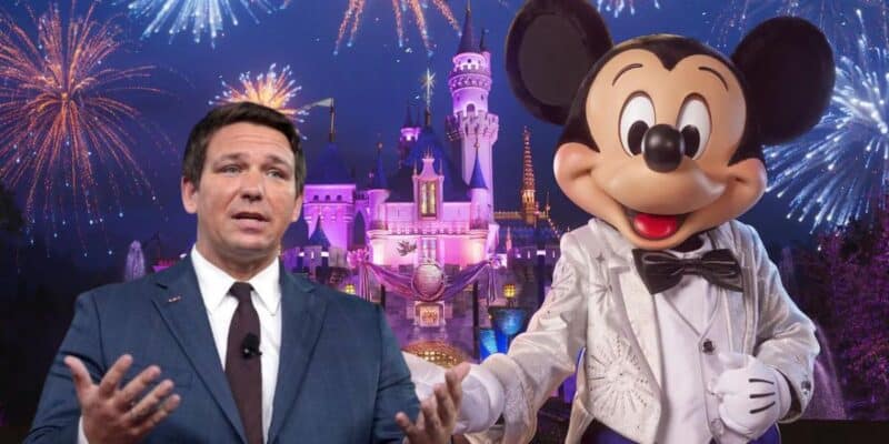 Ron DeSantis with his hands raised next to Mickey Mouse in a white dinner coat