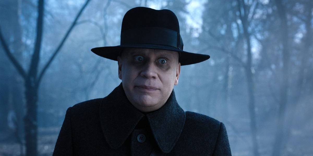 Uncle Fester (Fred Armisen) looking creepy in the woods in Wednesday