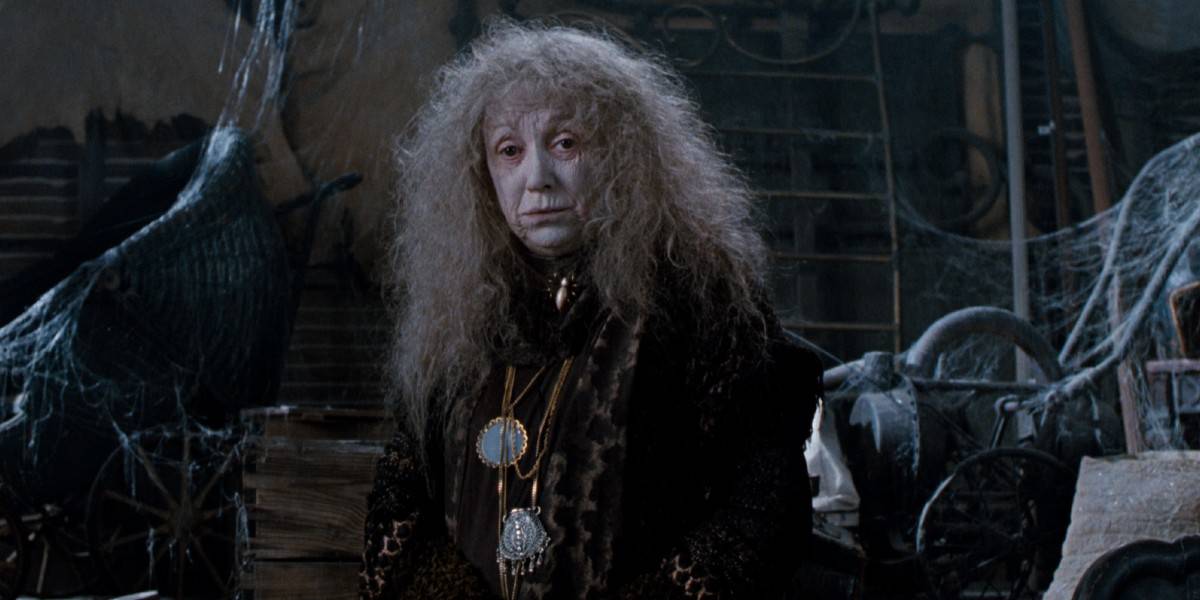 Grandma Addams (Judith Malina) standing in a dust-covered room in The Addams Family (1991)
