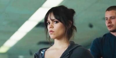 Jenna Ortega glowering with Toby Wallace in the background