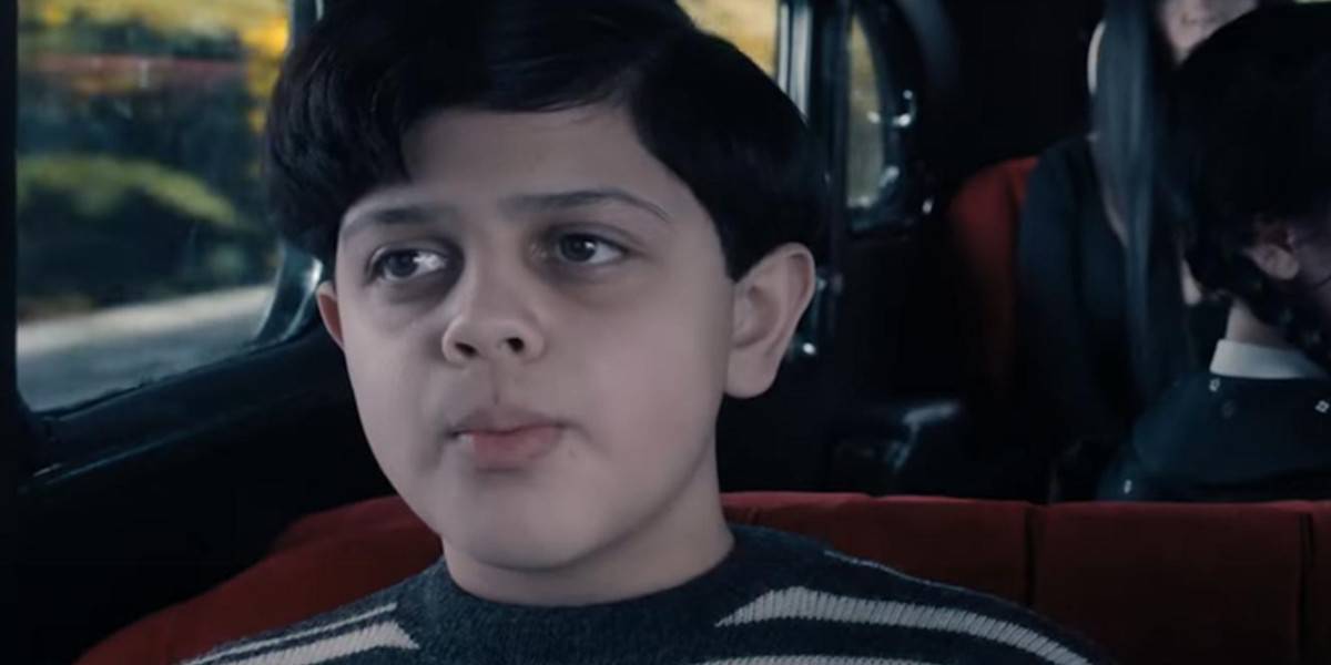Pugsley Addams (Isaac Ordonez) riding in the family car in Wednesday