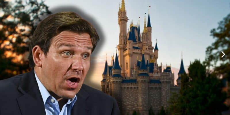 A shocked Ron DeSantis looking towards the Cinderella Castle at Magic Kingdom Park at Disney World.