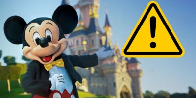 Mickey Mouse in front of the Sleeping Beauty Castle at Disneyland Paris.
