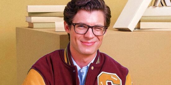 David Corenswet edited to look like Clark Kent, winking while wearing glasses and a red and yellow "S" branded letterman jacket, holding an open book.