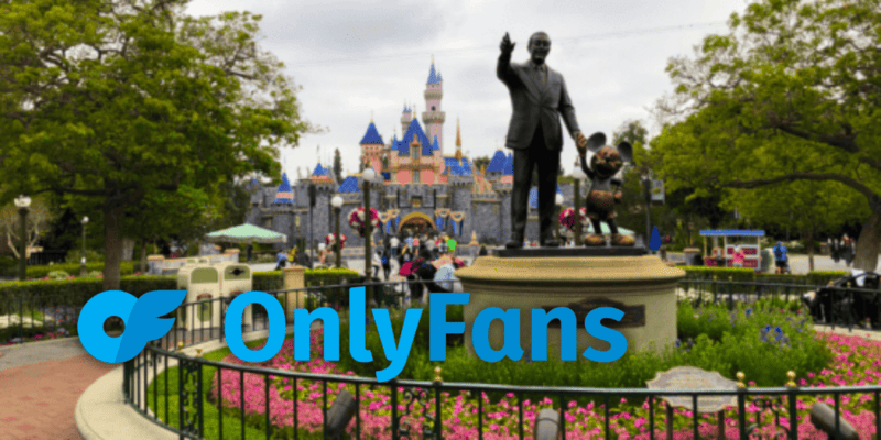 The OnlyFans Logo edited in front of sleeping beauty castle and the partners statue at Disneyland Park.
