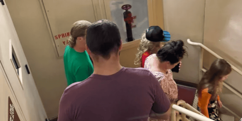 Guests go down the stairs while evacuating Disney's Paradise Pier Hotel.