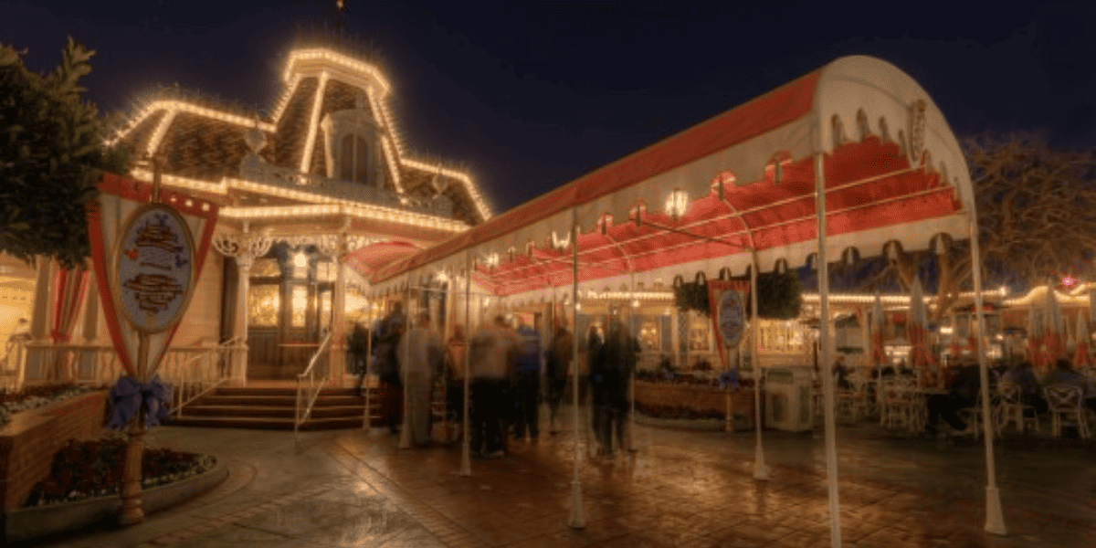 The exterior of the Plaza Inn at Disneyland Park at nighttime.