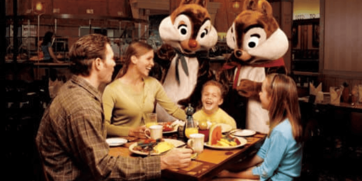 Chip & Dale greet a family at their table at Storytellers Cafe.