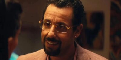 Adam Sandler smiling awkwardly in Uncut Gems